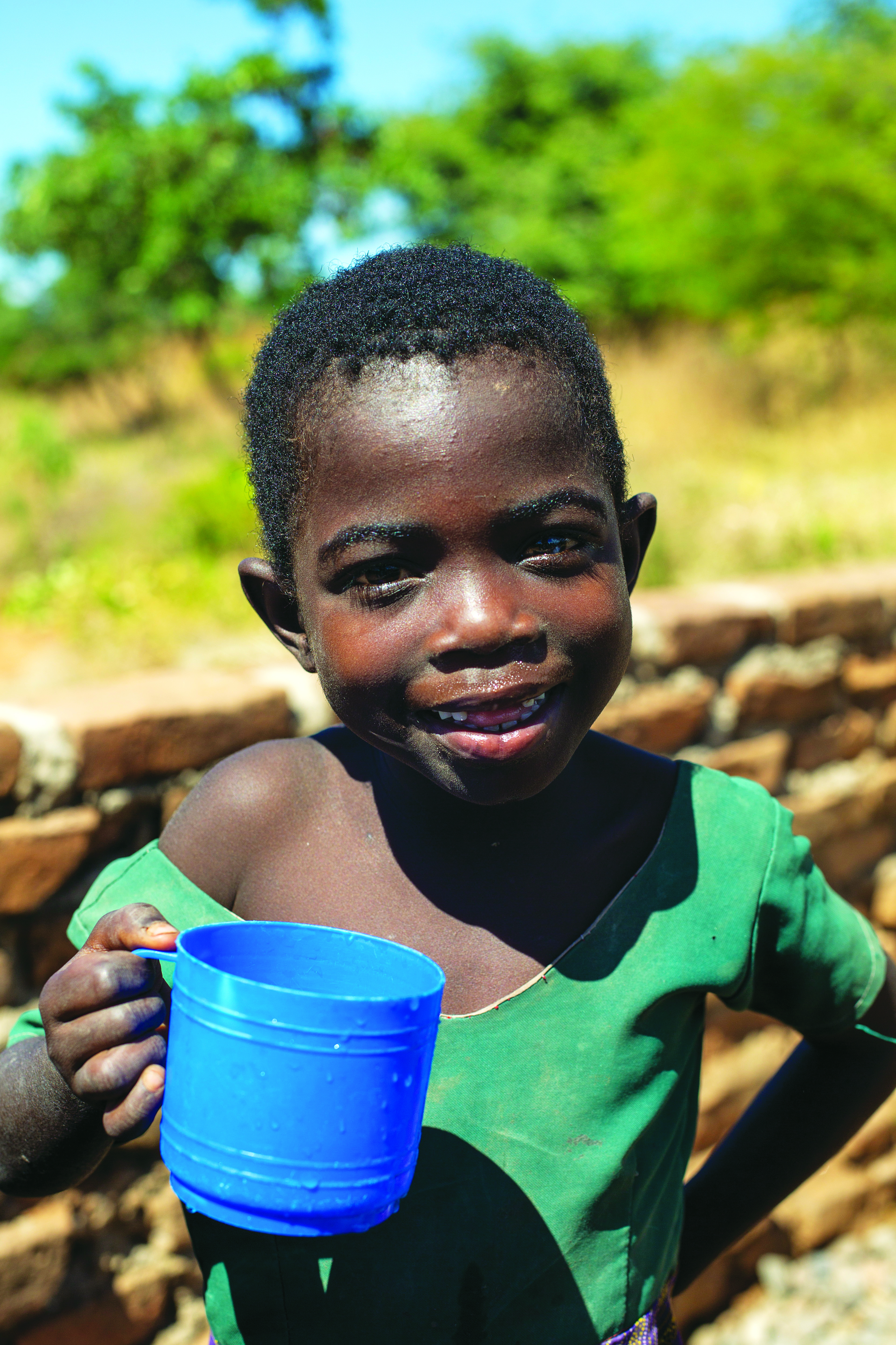 Poor child carrying water